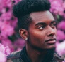 a man looking away with floral background